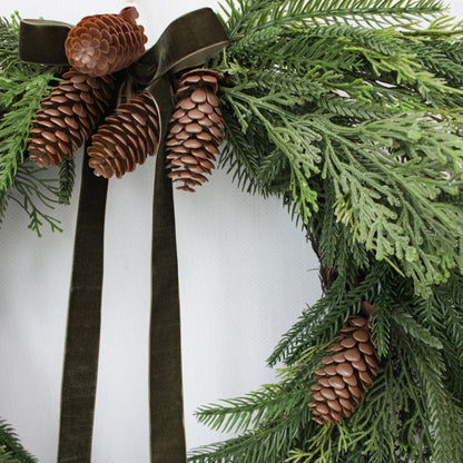 24 inch holiday pine wreath with pinecones and green ribbon